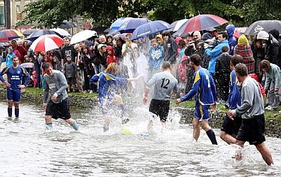 Umbrellas are the order of the day for river football spectactors...even when it's not raining.